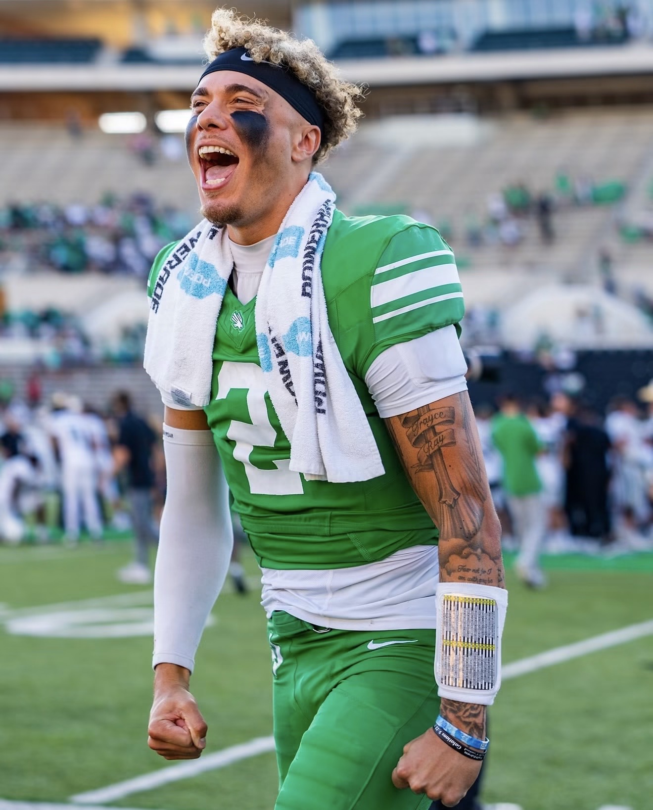 Tayven Jackson celebrating in a green North Texas football uniform